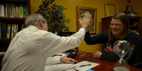 Tom and Kim Stegemoller laughing while with hands up here
