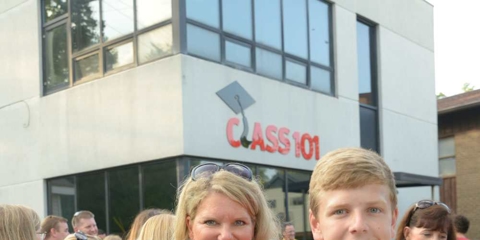 Mom and two young boys smiling