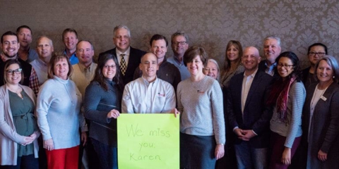 Group picture of team holding a banner