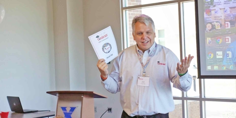 Man talking while holding some paper