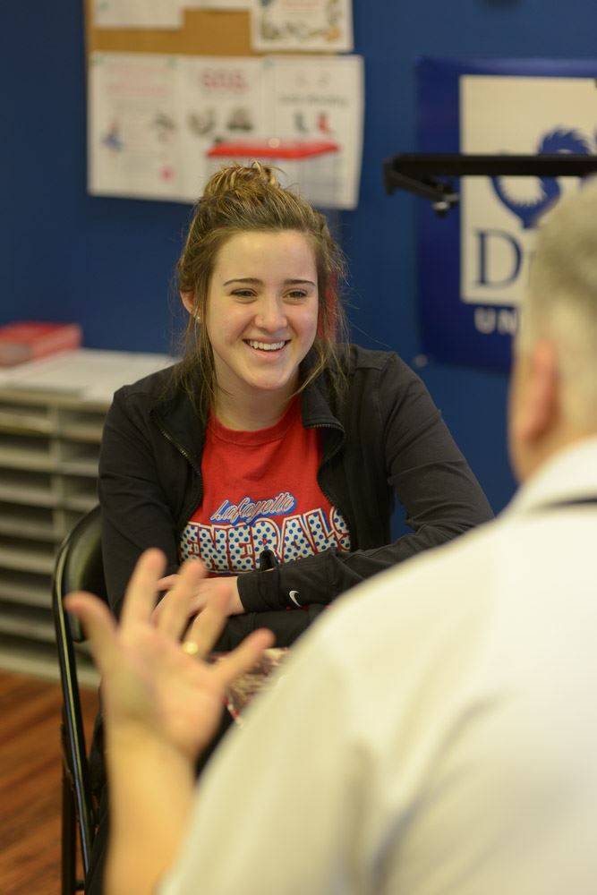 Woman smiling while listening to a man talking