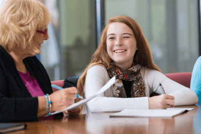 Girl studying by teachers