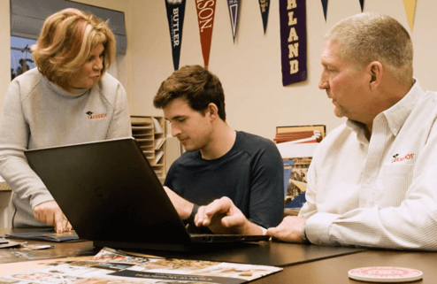 Boy studying with teachers