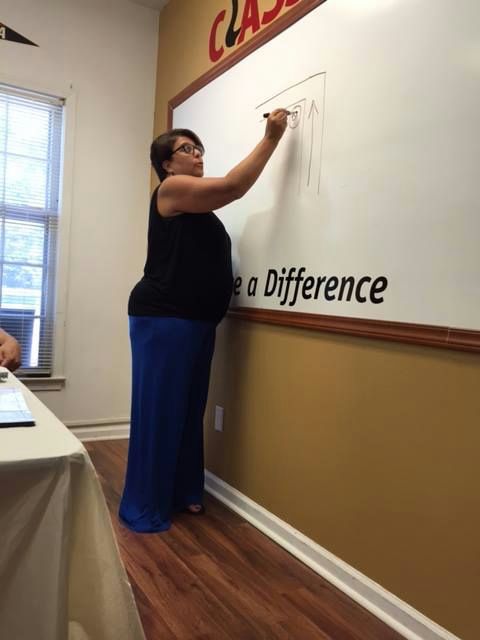 Woman drawing something on a whiteboard