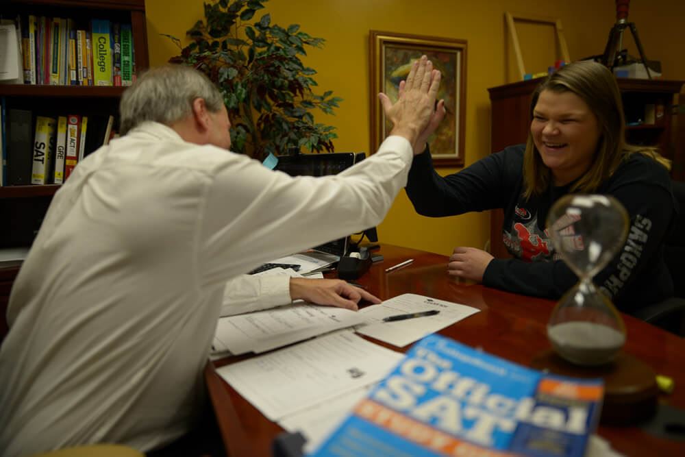 Tom and Kim Stegemoller laughing while with hands up here