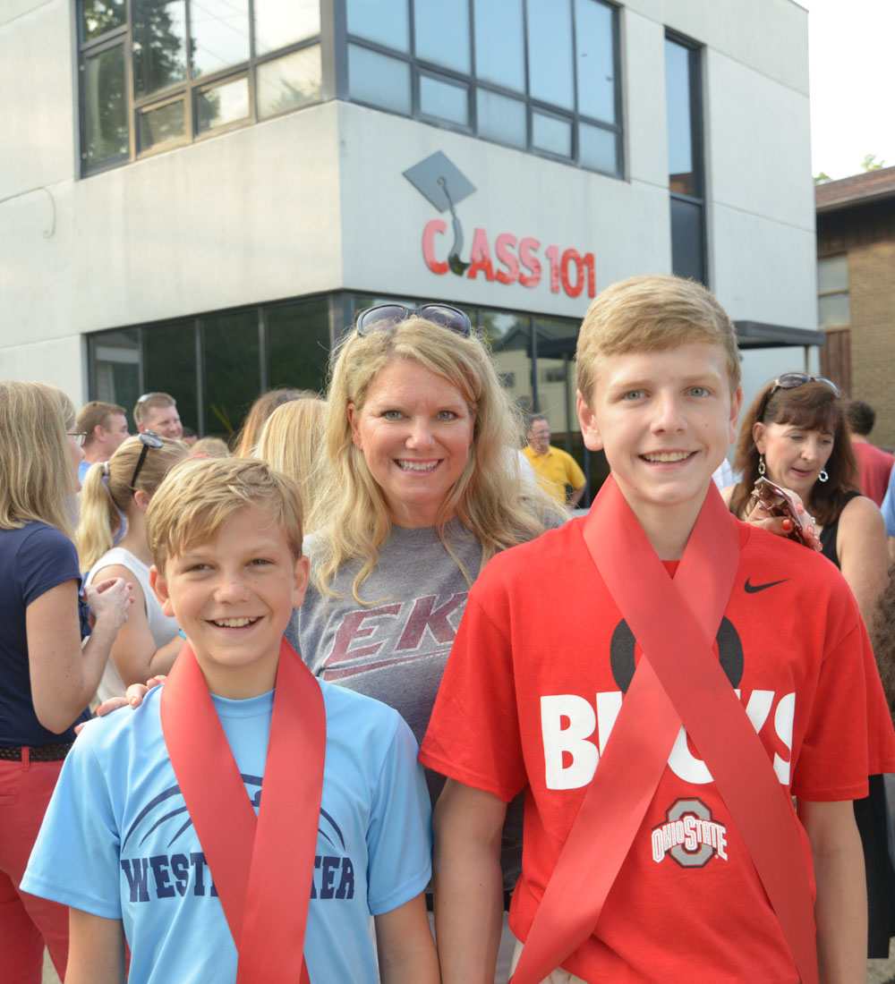 Mom and two young boys smiling