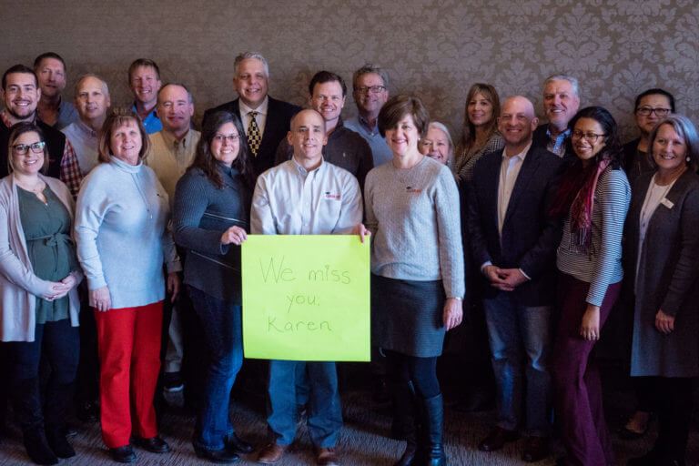 Group picture of team holding a banner