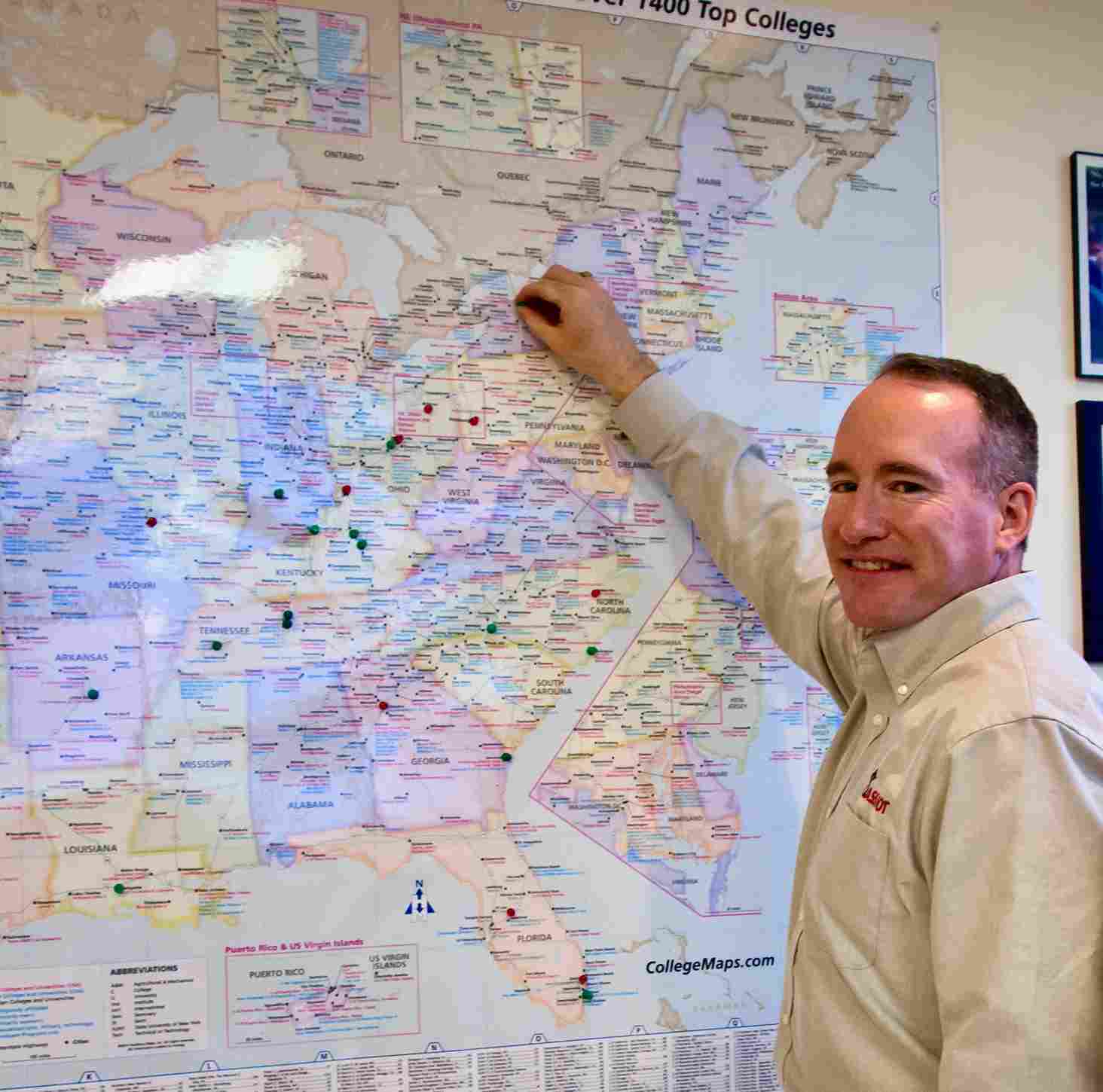 Man holding a pin on a map