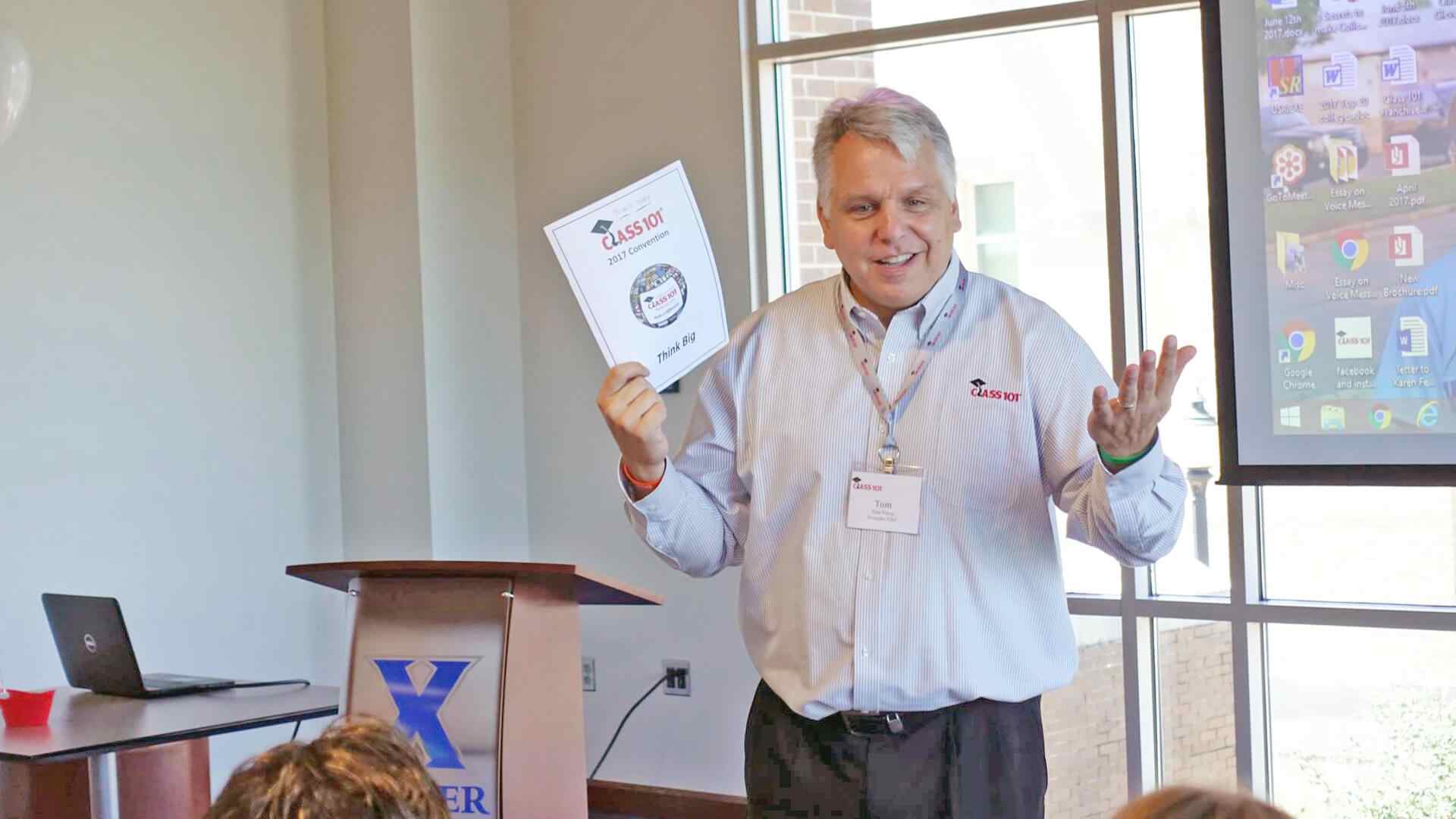 Man holding paper speaking